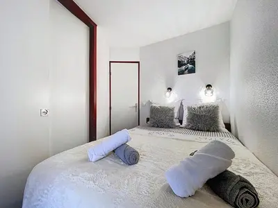 a living room with a couch and a table at Coeur de Chamonix, Appartement, parking in Chamonix-Mont-Blanc
