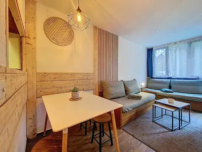 a small living room with a table and a couch at P'tiot Chamois Appartement Chamonix, Parking in Chamonix-Mont-Blanc