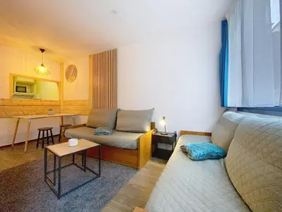 a small room with a bed and a table at P'tiot Chamois Appartement Chamonix, Parking in Chamonix-Mont-Blanc
