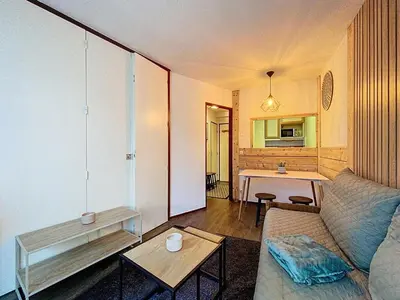 a living room with a couch and a table at P'tiot Chamois Appartement Chamonix, Parking in Chamonix-Mont-Blanc