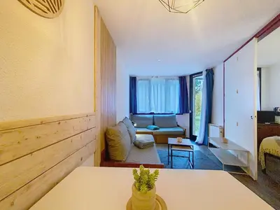 a living room with a couch and a table at P'tiot Chamois Appartement Chamonix, Parking in Chamonix-Mont-Blanc
