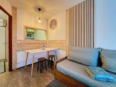 a living room with a couch and a table at P'tiot Chamois Appartement Chamonix, Parking in Chamonix-Mont-Blanc