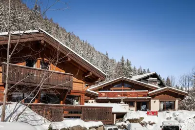 a log cabin in the winter with snow on it at Chalet Chardonnet in Chamonix-Mont-Blanc