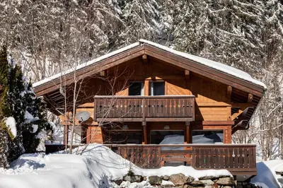 a log cabin in the snow in the woods at Chalet Chardonnet in Chamonix-Mont-Blanc