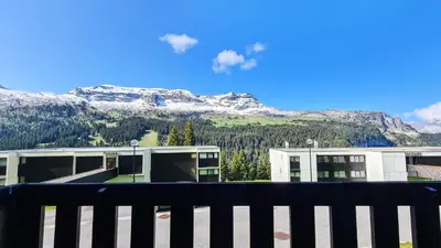a view of a building with a snow covered mountain at Résidence Gemeaux - Studio confortable · Centre station · Balcon MAE-7844 in Magland