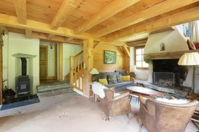a living room with a couch and a fireplace at Chalet de charme - 8 pers - 140m2 - Jardin - Calme in Les Houches