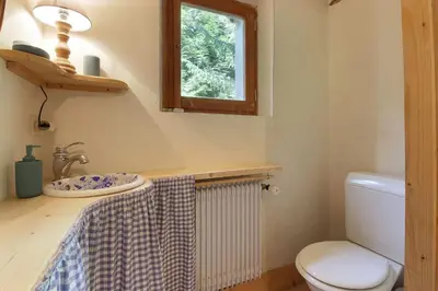 a bathroom with a sink and a toilet and a window at Chalet de charme - 8 pers - 140m2 - Jardin - Calme in Les Houches