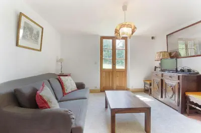 a living room with a couch and a table at Chalet de charme - 8 pers - 140m2 - Jardin - Calme in Les Houches