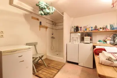 a small kitchen with a white refrigerator and a chair at Chalet de charme - 8 pers - 140m2 - Jardin - Calme in Les Houches