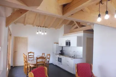 a kitchen and dining room with a table and chairs at demi chalet Les Contamines Le Virolet in Les Contamines-Montjoie