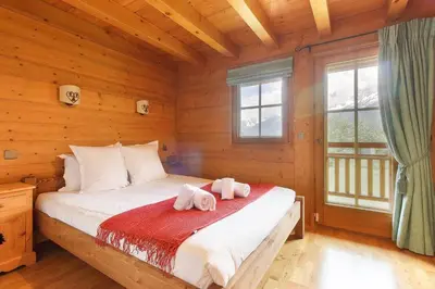 a bedroom with a bed with towels on it at Maison Neuve - Ski aux pieds - Vue Mt-Blanc in Les Houches