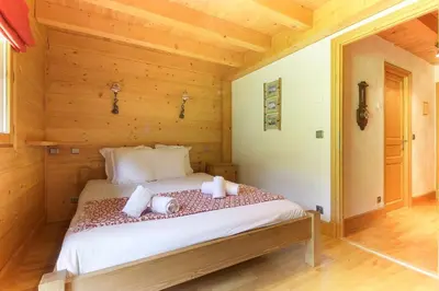 a bedroom with a bed with towels on it at Maison Neuve - Ski aux pieds - Vue Mt-Blanc in Les Houches