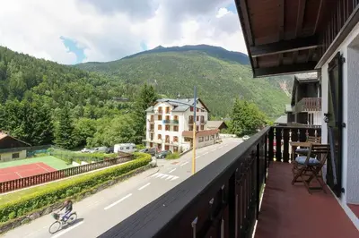 a person riding a bike on a balcony at La Griaz - Chaleureux et cosy -Vue sur les montagnes - grand balcon in Les Houches