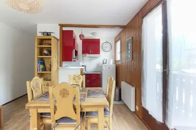 a kitchen and dining room with a table and chairs at La Griaz - Chaleureux et cosy -Vue sur les montagnes - grand balcon in Les Houches