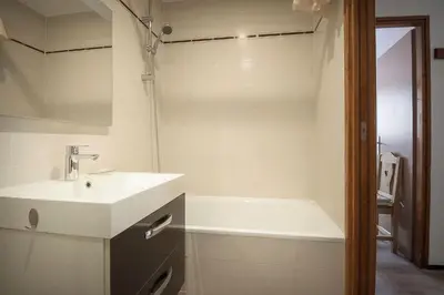 a bathroom with a sink and a bath tub at La Griaz - Chaleureux et cosy -Vue sur les montagnes - grand balcon in Les Houches