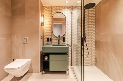 a bathroom with a toilet and a sink and a mirror at Rochebrune - Appartement de luxe in Megève