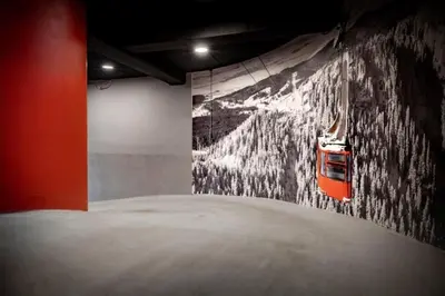 a room with a painting of a train on the wall at Rochebrune - Appartement de luxe in Megève