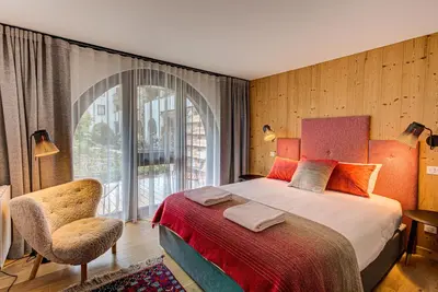 a bedroom with a bed and a large window at Apartment Chéserys, Alpes Travel, Les Praz Sleeps 2-4 in Chamonix-Mont-Blanc