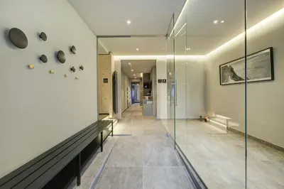 a hallway of a house with a glass wall at Apartment Chéserys, Alpes Travel, Les Praz Sleeps 2-4 in Chamonix-Mont-Blanc