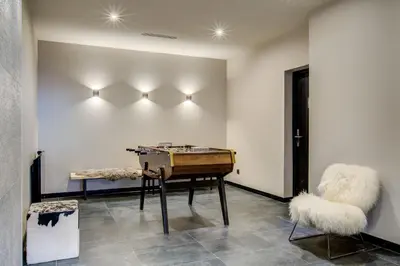 a room with a piano and a chair and lights at Apartment Chéserys, Alpes Travel, Les Praz Sleeps 2-4 in Chamonix-Mont-Blanc
