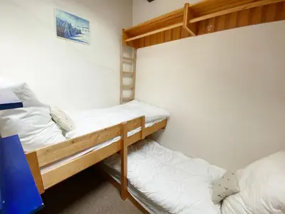 a small bedroom with a bed and a table at Appartement 2 pièces mezzanine au pied des pistes - 5 personnes - FR-1-815-91 in Morillon