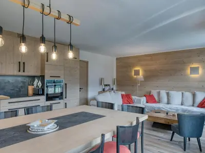 a kitchen and living room with a table and a couch at Confortable 3 pièces à Megève avec Wi-Fi et garage à skis - FR-1-453-306 in Megève