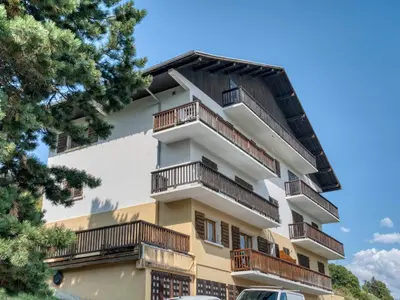 an apartment building with balconies and trees at Confortable 3 pièces à Megève avec Wi-Fi et garage à skis - FR-1-453-306 in Megève