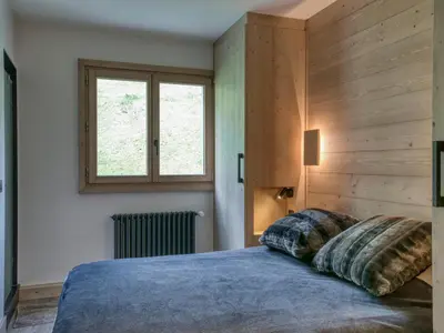 a bedroom with a bed with two pillows on it at Confortable 3 pièces à Megève avec Wi-Fi et garage à skis - FR-1-453-306 in Megève