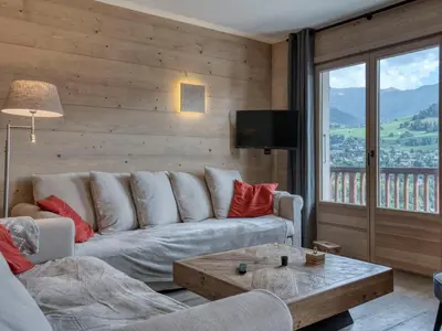 a living room with a couch and a table at Confortable 3 pièces à Megève avec Wi-Fi et garage à skis - FR-1-453-306 in Megève