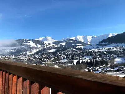 a view of a town with snow covered mountains at Confortable 3 pièces à Megève avec Wi-Fi et garage à skis - FR-1-453-306 in Megève
