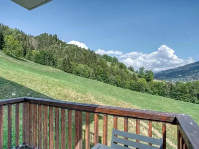 a wooden deck with a bench on a hill at Confortable 3 pièces à Megève avec Wi-Fi et garage à skis - FR-1-453-306 in Megève