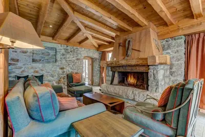 a living room with a couch and a fireplace at Spacious 3-bed in the heart of Chamonix with sauna in Chamonix-Mont-Blanc