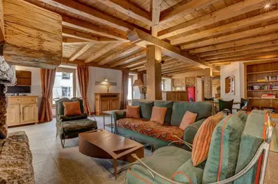 a living room with a couch and a table at Spacious 3-bed in the heart of Chamonix with sauna in Chamonix-Mont-Blanc