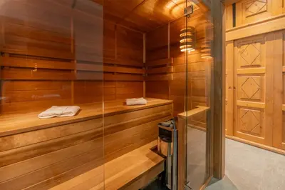 a sauna with wooden walls and a glass door at Spacious 3-bed in the heart of Chamonix with sauna in Chamonix-Mont-Blanc
