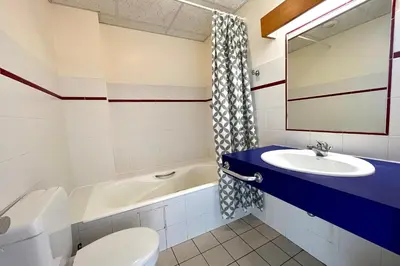 a bathroom with a sink and a toilet and a tub at Premier de Cordée in Combloux