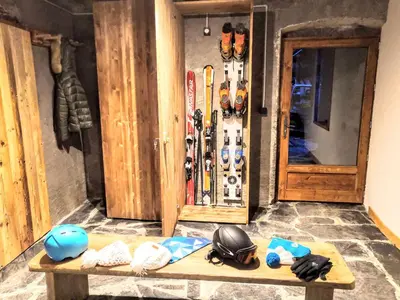 a bunch of skis and helmets sitting on a bench at Chez Lucienne, jacuzzi et sauna in Samoëns