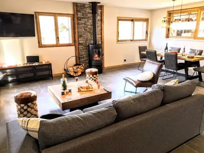 a living room with a couch and a fireplace at Chez Lucienne, jacuzzi et sauna in Samoëns