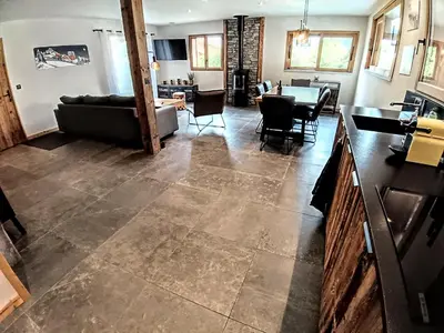 a living room with a couch and a table at Chez Lucienne, jacuzzi et sauna in Samoëns