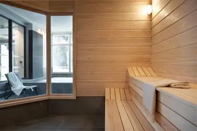 a sauna with a bench in a wooden wall at MGM Hôtels & Résidences - Résidence Alhéna in Flaine