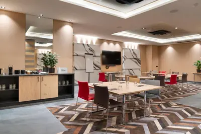 a conference room with tables and chairs and a tv at MGM Hôtels & Résidences - Résidence Alhéna in Flaine