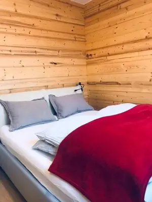 a bedroom with a bed with a red blanket on it at Aiguille Rouge in Chamonix-Mont-Blanc