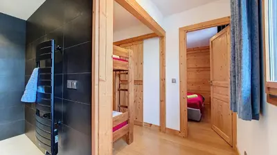 a small bathroom with wooden walls and a walk in closet at Aiguille Rouge in Chamonix-Mont-Blanc