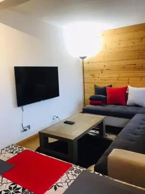 a living room with a couch and a flat screen tv at Aiguille Rouge in Chamonix-Mont-Blanc