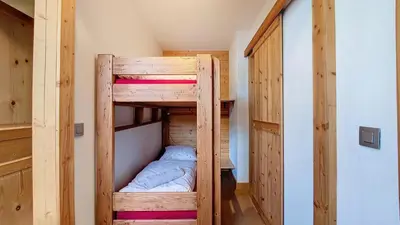 a wooden bunk bed in a small room at Aiguille Rouge in Chamonix-Mont-Blanc