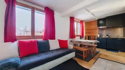 a living room with a couch and a kitchen at Aiguille Rouge in Chamonix-Mont-Blanc
