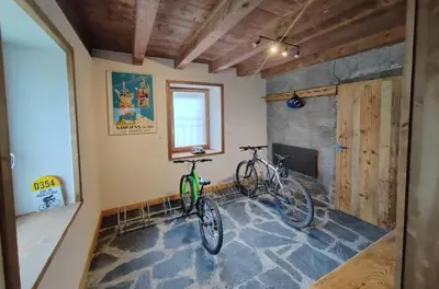 two bikes parked in a room with a fireplace at Chez Léon Jacuzzi et sauna in Samoëns
