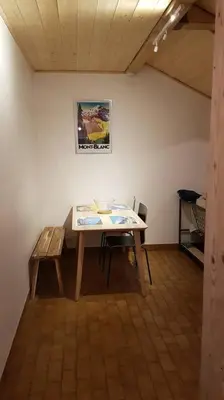 a room with a table and a painting on the wall at Appartement Les Dents Blanches - Samöens Centre in Samoëns