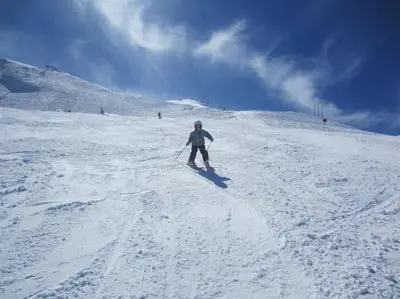 a person is skiing down a snow covered slope at Appartement Les Dents Blanches - Samöens Centre in Samoëns