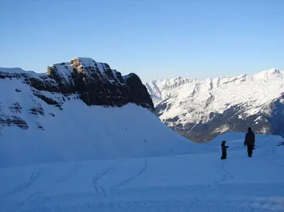 a man and a child standing on a snow covered mountain at Appartement Les Dents Blanches - Samöens Centre in Samoëns