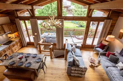 a living room with a couch and a table at Chalet du Dard - Chamonix All Year in Chamonix-Mont-Blanc